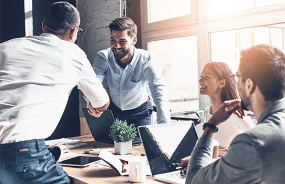 Glad,To,Work,With,You!,Young,Modern,Men,In,Smart Glad to work with you! Young modern men in smart casual wear shaking hands and smiling while working in the creative office